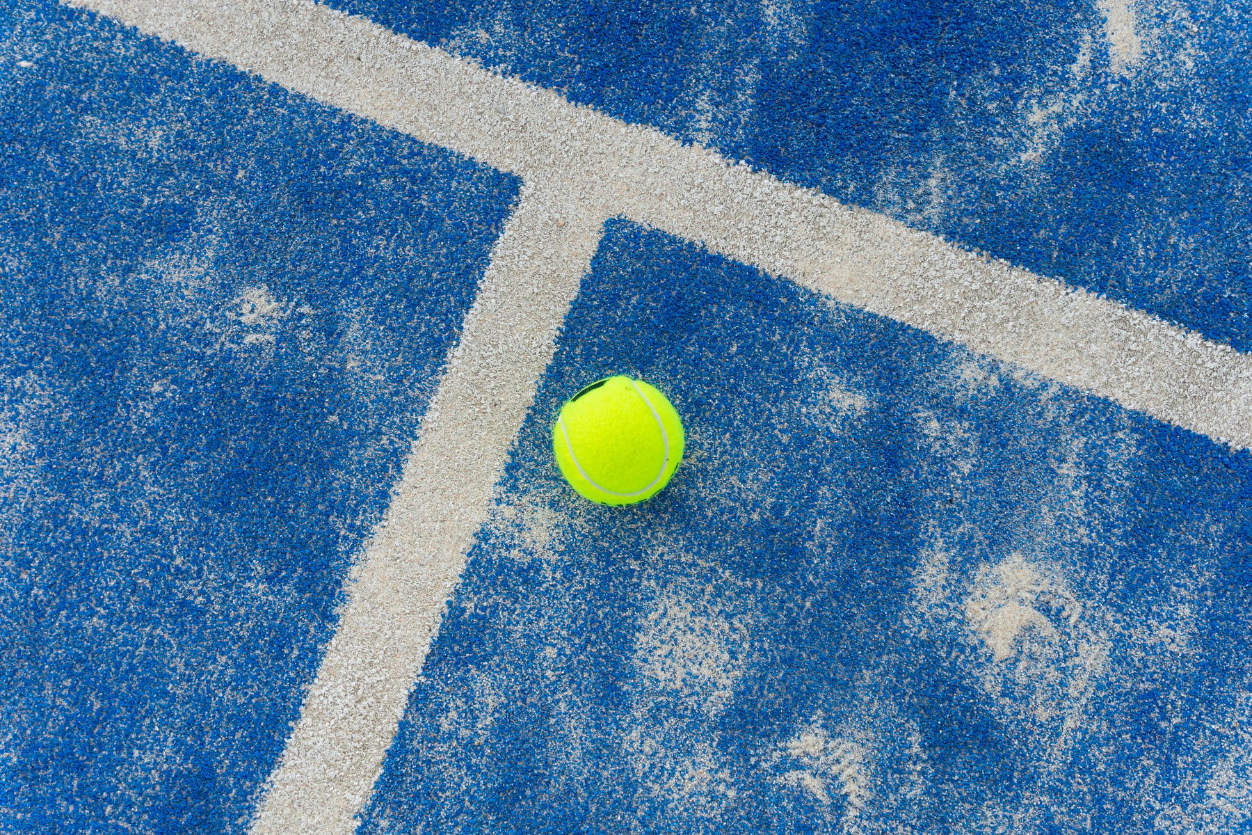 Paddle tennis ball on the court for background.